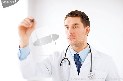 Image of young doctor working with something imaginary