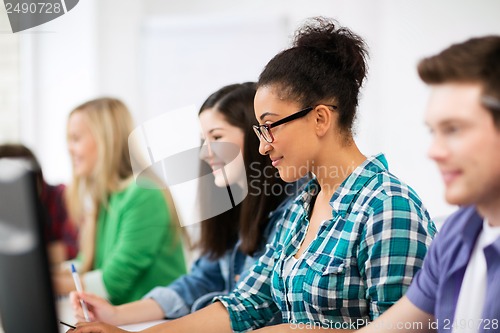 Image of african student with computer studying at school