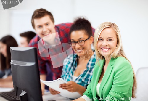 Image of students with computer studying at school