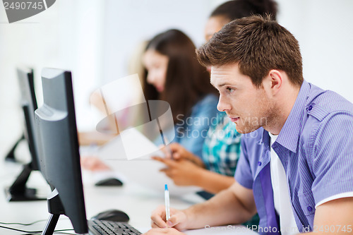 Image of student with computer studying at school