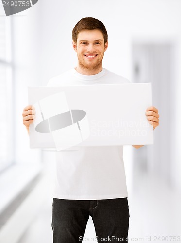 Image of young man holding white blank board