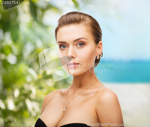 Image of woman wearing shiny diamond earrings