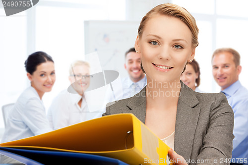 Image of woman with folders in office