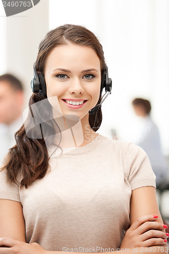 Image of helpline operator with headphones in call centre