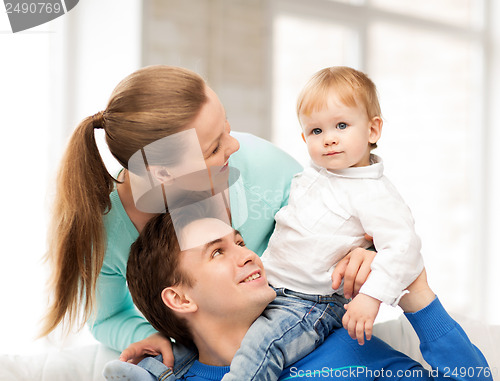 Image of happy parents playing with adorable baby