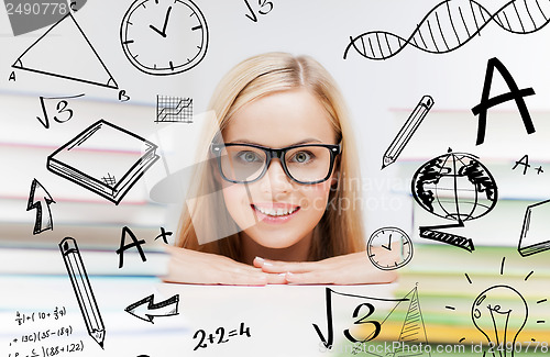 Image of student with stack of books and doodles