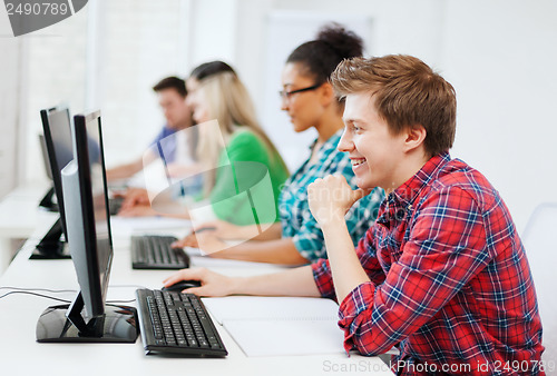 Image of student with computer studying at school