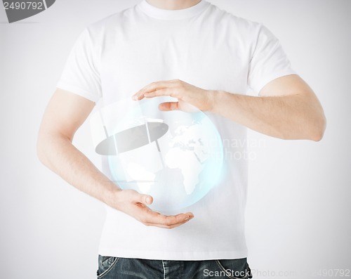 Image of man hands holding sphere globe