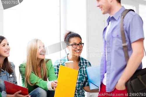 Image of students communicating and laughing at school