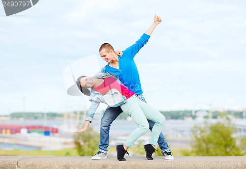 Image of couple of teenagers dancing outside