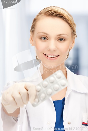 Image of doctor with blister pack of pills