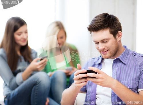 Image of students looking into devices at school