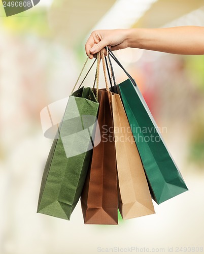 Image of woman hands holding shopping bags