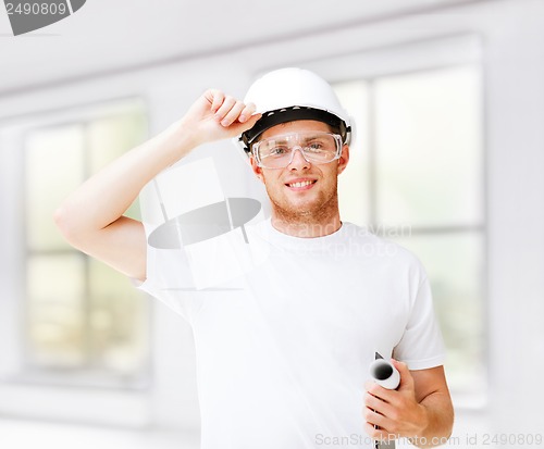 Image of male architect in helmet with blueprint