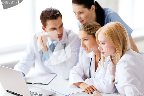 Image of group of doctors looking at tablet pc