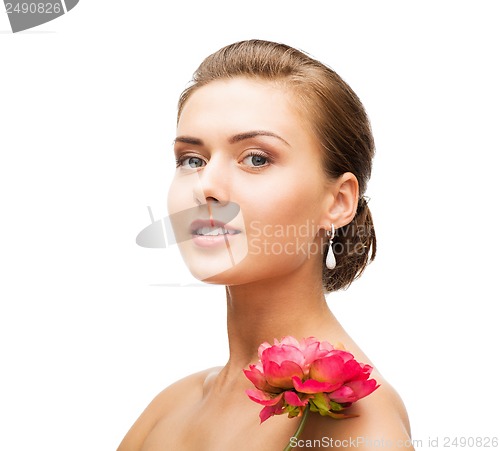 Image of woman wearing earrings with flower