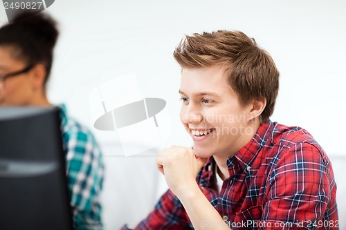 Image of student with computer studying at school