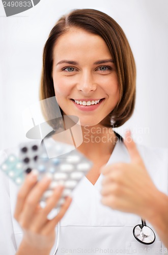 Image of doctor with blister packs of pills