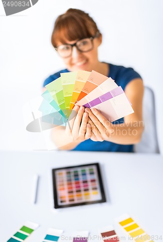 Image of woman showing pantone color samples