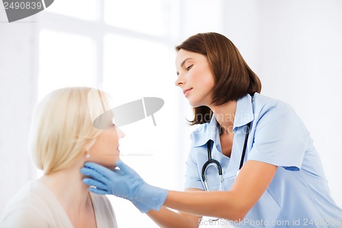 Image of plastic surgeon or doctor with patient