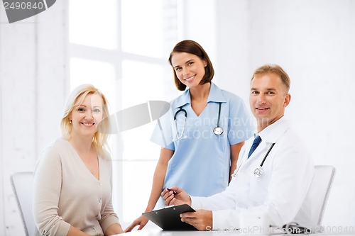 Image of doctor and nurse with patient in hospital