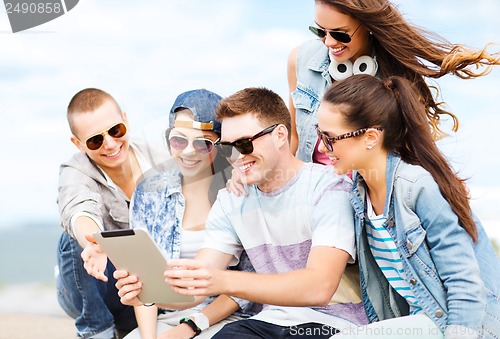 Image of group of teenagers looking at tablet pc