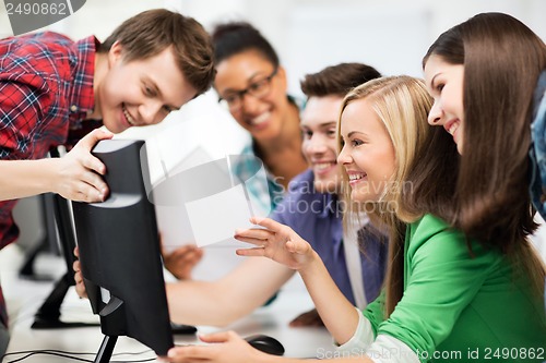 Image of students looking at computer monitor at school