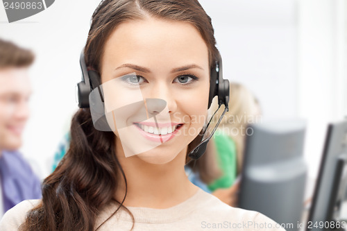 Image of helpline operator with headphones in call centre