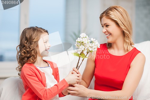 Image of happy mother and daughter with flowers