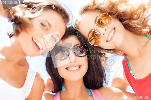 Image of girls faces with shades looking down