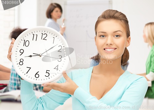 Image of attractive student pointing at clock