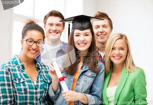 Image of girl in graduation cap with certificate