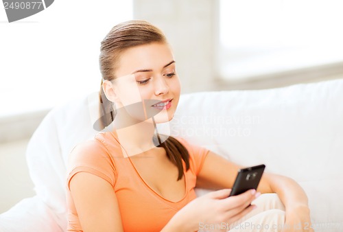 Image of woman with smartphone at home