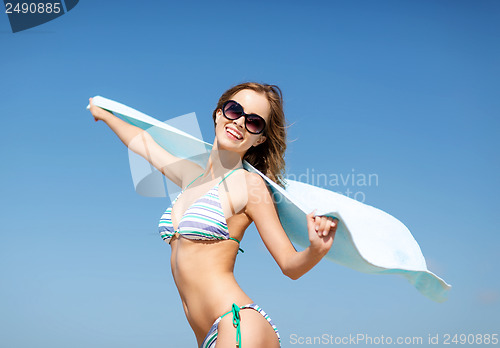 Image of girl in bikini and shades on the beach