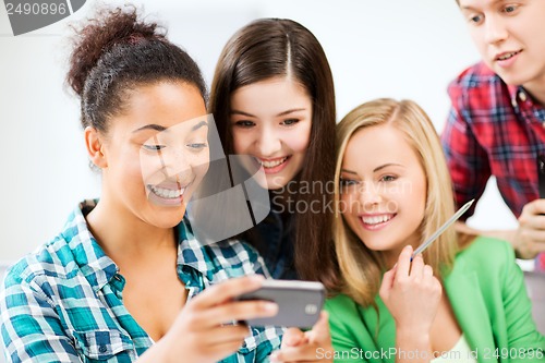 Image of students looking at smartphone at school