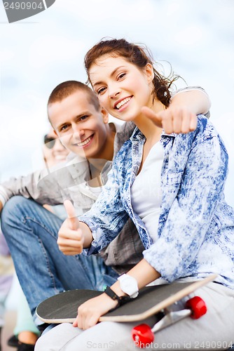 Image of teenages with skateboard outside