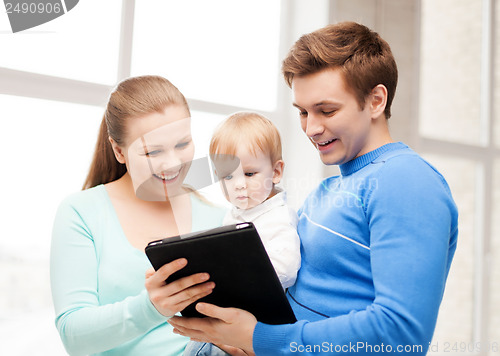 Image of parents and adorable baby with tablet pc
