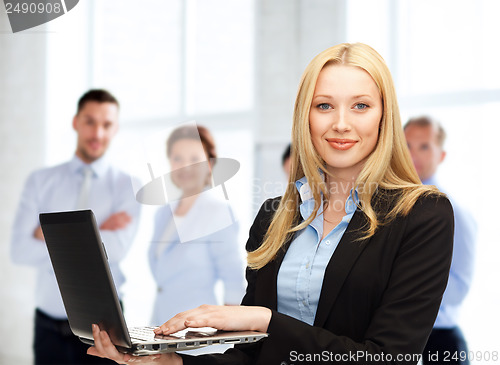 Image of businesswoman with laptop computer at work