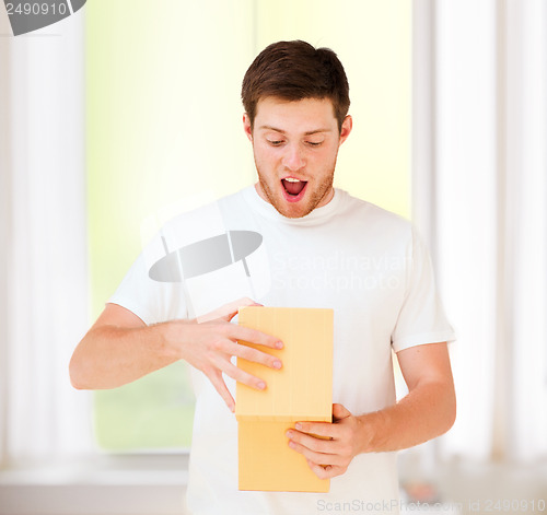 Image of man in white t-shirt with gift box