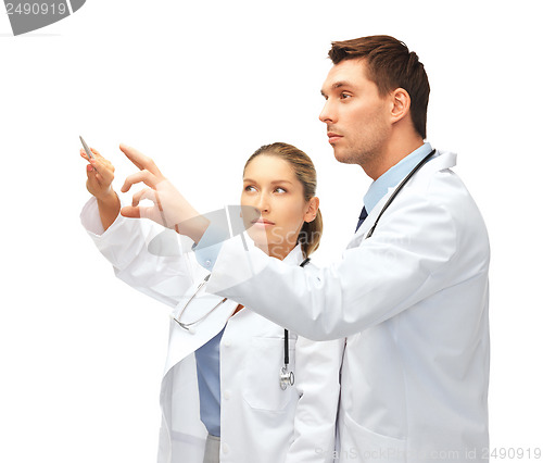 Image of young doctors working with something imaginary