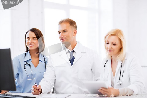 Image of doctors looking at computer on meeting