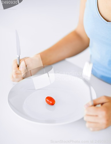 Image of woman with plate and one tomato