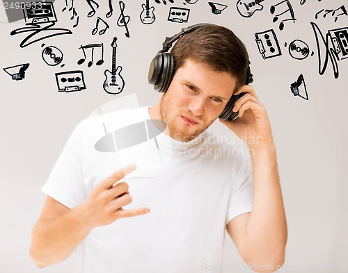 Image of man with headphones listening rock music