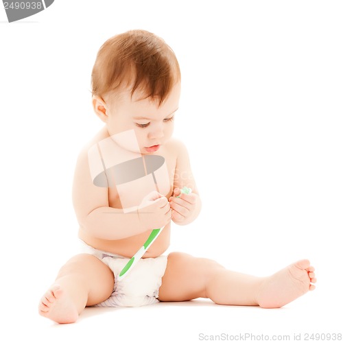 Image of curious baby brushing teeth