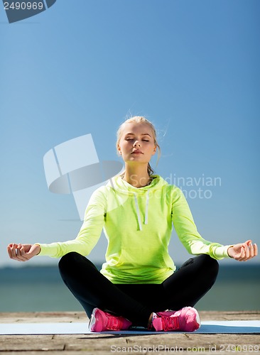 Image of woman doing yoga outdoors