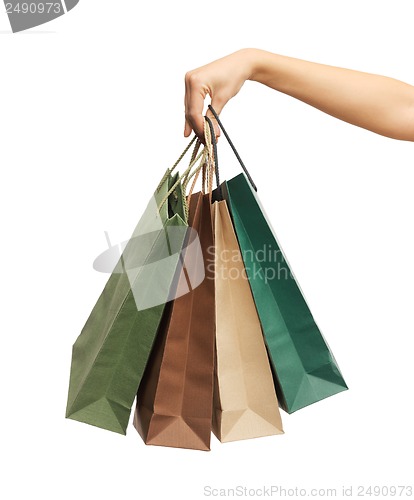 Image of woman hands holding shopping bags