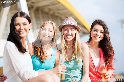 Image of girls with drinks on the beach