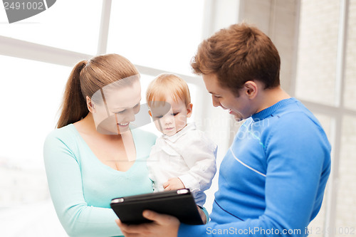 Image of parents and adorable baby with tablet pc