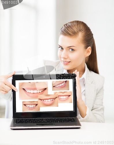 Image of woman with laptop and smiles