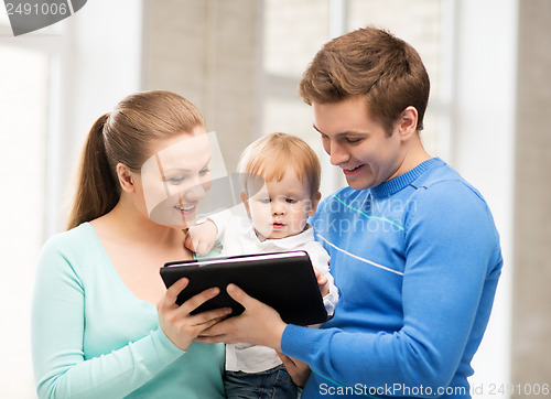 Image of parents and adorable baby with tablet pc